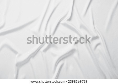 Texture of white crumpled silk fabric as background, top view