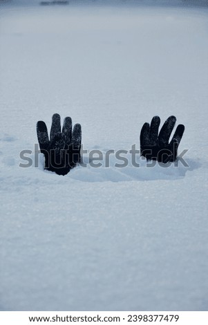 Gloves sticking out from the snow after a blizzard hits Montreal, Quebec, Canada Royalty-Free Stock Photo #2398377479