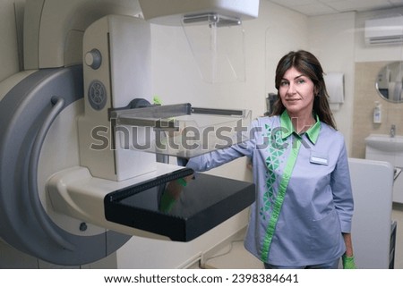 Radiologic technologist posing for camera among diagnostic equipment in clinic Royalty-Free Stock Photo #2398384641