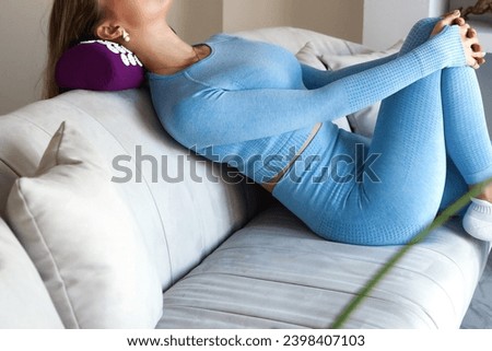 Woman doing self body health neck massage on orthopedic acupressure pillow with thin needles. Adult lady in blue sportswear, acupressure mat therapy. Healthcare medical concept. Copy ad text space Royalty-Free Stock Photo #2398407103