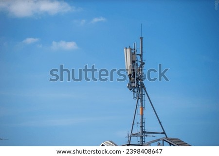 Telecommunication tower with blue sky and white clouds, technology background.                         
