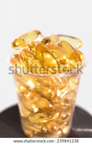 Healthy natural omega cod fish liver oil capsules in a cup