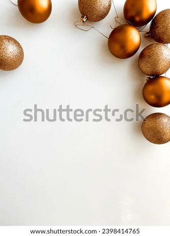 Colorful Christmas balls for the Christmas tree on a white background. Flat lay of bronze Christmas balls top view. Place for text
