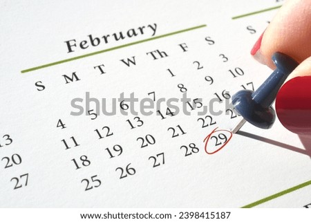 Marking Leap Year Day, February 29, on a calendar with a pushpin and red circle in ink Royalty-Free Stock Photo #2398415187