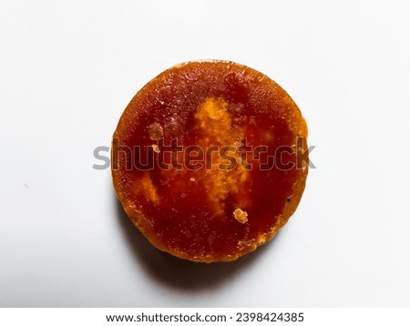 closeup of a round brown sugar isolated on a white background.  top view