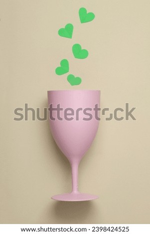 Plastic glass with hearts on a pastel background on a pastel background. Romantic, Love concept
