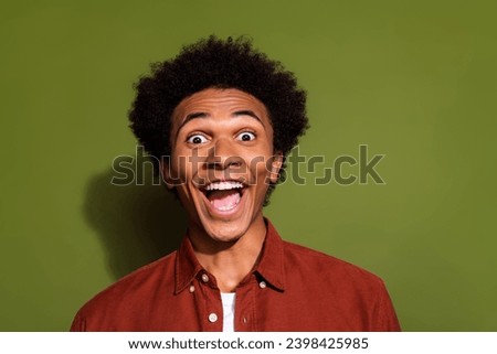 Photo of crazy eccentric man with afro hair dressed brown shirt astonished staring at unbelievable sale isolated on khaki color background
