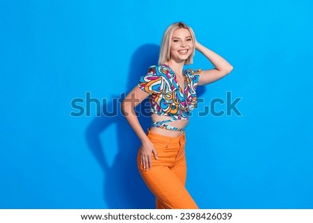 Photo of pretty adorable woman with bob hairdo dressed print blouse posing for magazine cover isolated on bright blue color background