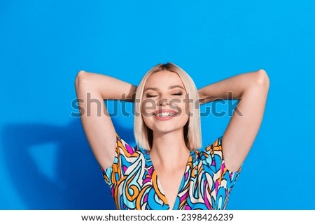 Photo of good mood woman with bob hairdo dressed print blouse arms behind head eyes closed isolated on bright blue color background