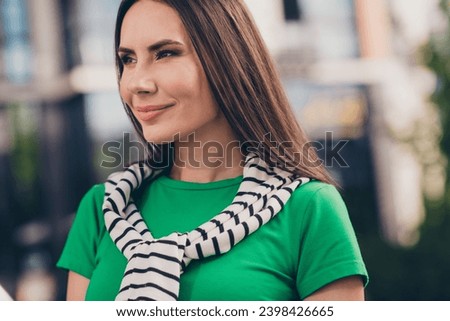 Photo of thoughtful good mood girl dressed green top enjoying warm sunshine walking outdoors urban town park