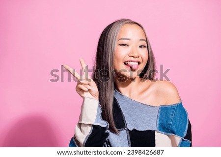 Photo of cheerful carefree lady show tongue out hello greetings v-sign isolated on pink color background