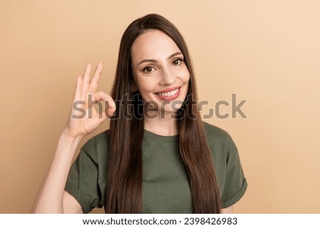 Portrait of mature cheerful happy businesswoman show okey sign advertising new product for daily using isolated on beige color background
