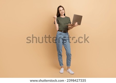 Full body photo of lady sales manager on amazon shopify service using laptop point finger mockup prices isolated over beige color background