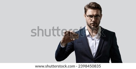 Bank card. Business man holding a credit card on gray isolated background. Hispanic man showing credit card. Credit or deposit bank card. Offer discount sale, online shopping. Banner with copy space.