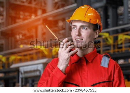 Electrical engineer railway checking construction process electric train and maintenance station .Engineer wearing safety uniform and helmet by using walki-talkie in work. transportation, transport.