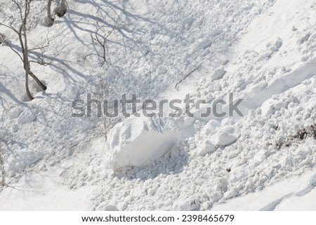 Large lump of snow at bottom of avalanche Royalty-Free Stock Photo #2398465679