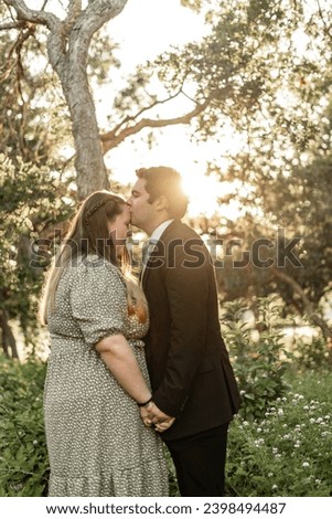matching couple portraits in their Sunday best engagement wedding pictures in magical garden looking area