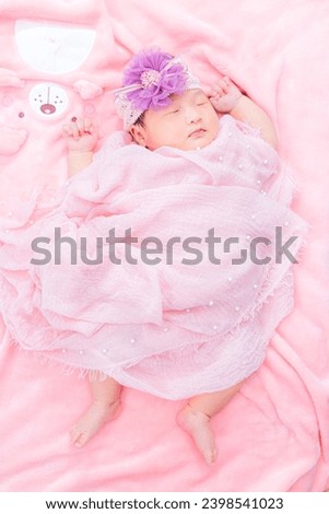 Newborn baby,Close-up beautiful sleeping baby boy. Newborn baby sleeping on a blanket, beautiful pictures, seven days, newborn baby wearing large cloth, cloth rose headband