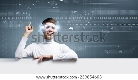 Young man wearing futuristic glasses against blue background with white banner