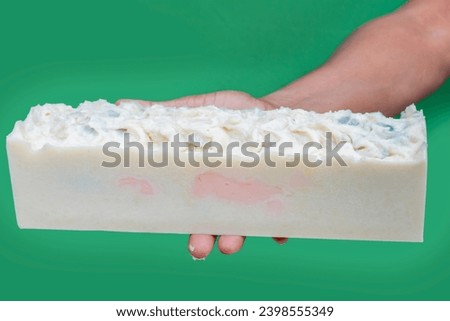 Handmade soap with green background.
