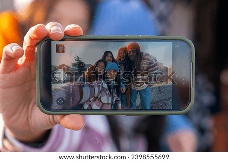 selfie on smartphone point of view of five young friends of different ethnicities 