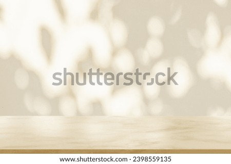 Empty marble table top on white wall texture with tree leaves shadow background