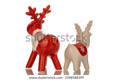Two ceramic Christmas deer, macro, isolated on white background.