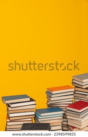 Many stacks of educational books to study in the university library on a background
