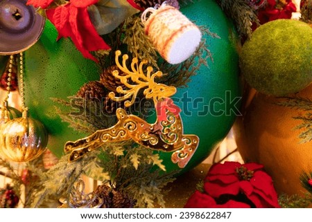 Christmas decoration with reindeer,  a dried pine cone, ball, leaf, branch. Christmas background. Christmastime celebration. 
