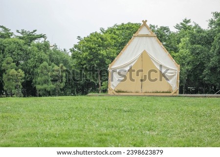 Camping tents on the park grassland Royalty-Free Stock Photo #2398623879