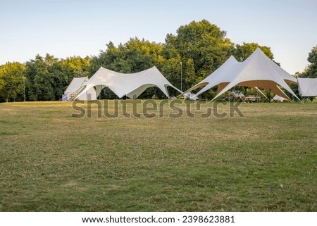 Camping tents on the park grassland Royalty-Free Stock Photo #2398623881