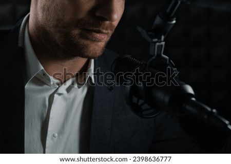 business podcast or radio interview recording. closeup of businessman talking in microphone in broadcasting studio