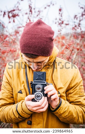 Male photographer with professional equipment is getting ready to take the photo