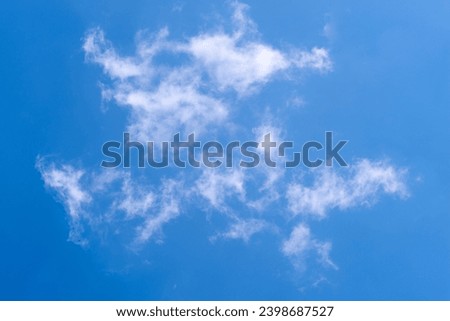 Bright blue sky with white clouds for background or wallpaper. The beauty of nature for graphic design, natural beauty, ecology and clean air. For desktop background, wallpaper. Natural textures.