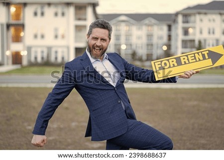 rent house with renter adviser man smile outdoor. photo of renter adviser man with for rent sign.
