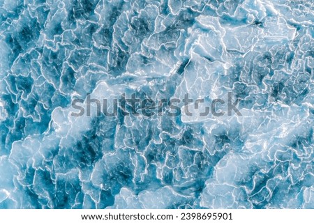 Aerial top down view of ice surface. Frozen sea surface texture Royalty-Free Stock Photo #2398695901