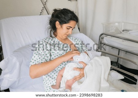 Caring mother with newborn baby in clinic
