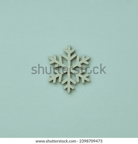 Christmas decoration in the shape of a snowflake on a blue background