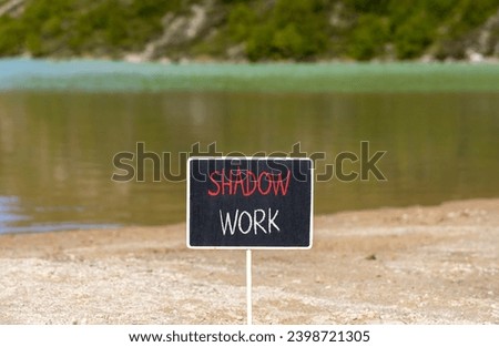 Shadow work psychology symbol. Concept words Shadow work on beautiful black chalk blackboard. Beautiful sand beach mountain lake background. Psychology shadow work concept. Copy space.