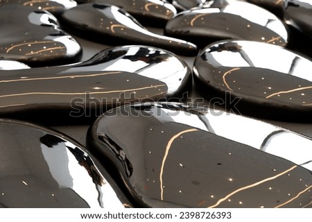 Full frame of monochrome abstract background representing gray colored drops of irregular shapes with shiny surface made of glossy metal fluid