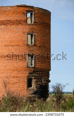 an old dilapidated brick silo Royalty-Free Stock Photo #2398731075