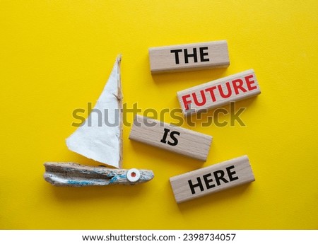 The future is here symbol. Concept words The future is here on wooden blocks. Beautiful yellow background with boat. Business and The future is here concept. Copy space.