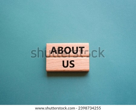 About us symbol. Concept word About us on wooden blocks. Beautiful grey green background. Business and About us concept. Copy space