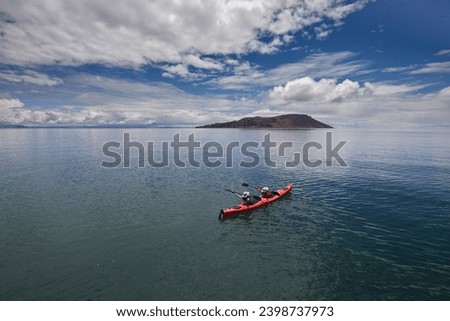 Sea kayaking on Lake Titicaca can be a unique and memorable experience, allowing you to explore its stunning landscapes, traditional communities, and ancient cultures Royalty-Free Stock Photo #2398737973