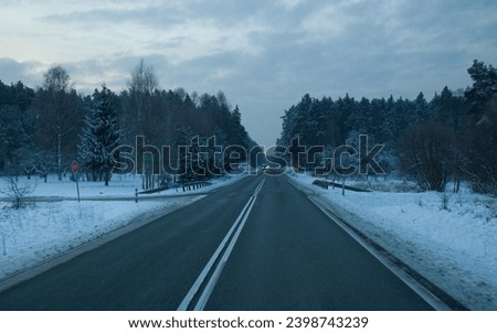 Winding road in winter on the sunrise. Snowy roads in winter time. Snowy tree and forests.