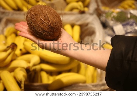coconut in hand in the supermarket