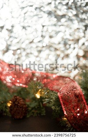 Close-up of a New Year's garland on a black background and a background of crumpled silver foil. photography with flash, 90s style.Place for text. Postcard. Merry Christmas and Happy New Year