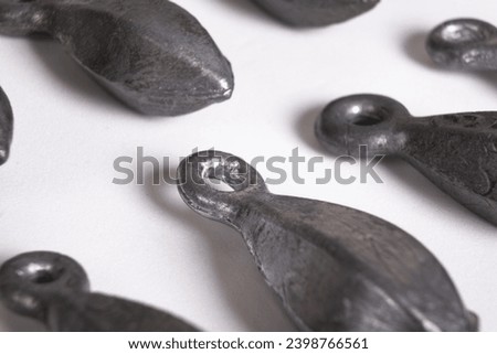 Lead fishing weights cast sinkers isolated on white background. Equipment or tools. Heap of bullet sinker weights for fishing, silver bank accessories Royalty-Free Stock Photo #2398766561