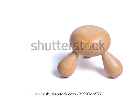 Wooden hands massager on isolated white background. Traditional manual hand massage tool made of wood