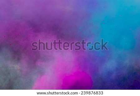 powder in different colours thrown into the air forming a huge cloud of smoke with little bits  Royalty-Free Stock Photo #239876833